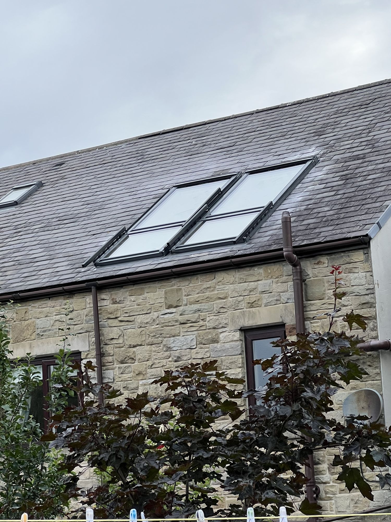 Stone-built cottage with two pairs of roof windows in the roof